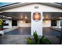 Unique home exterior with dual entrances, carport, and decorative sunburst, creating a welcoming curb appeal at 5009 21St W St, Bradenton, FL 34207