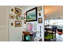 Bright entryway featuring decoratively adorned walls, an antique table and accents leading to the living space at 5030 Marsh Field Rd # 22, Sarasota, FL 34235