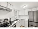 Updated kitchen featuring stainless steel appliances and modern lighting at 5907 Garden Ln # H26, Bradenton, FL 34207