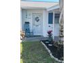 Close up of decorated front entrance to condo with plants and seating at 6032 Arlene Way, Bradenton, FL 34207