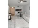 Open-concept living and dining area with modern furniture and a pass-through to the kitchen at 6924 Stones Throw N Cir # 8105, St Petersburg, FL 33710