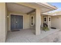 Inviting front porch showcasing a double door entry, brick flooring, and seating area at 7520 Curtiss Ave, Sarasota, FL 34231