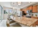 Bright kitchen with granite counters, stainless steel appliances, island seating and adjacent dining area at 803 Fairwaycove Ln # 106, Bradenton, FL 34212