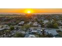 Sunset aerial view shows the neighborhood and location near the waterfront with easy access to nearby beaches at 101 Base E Ave # 101 103, Venice, FL 34285