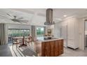 Bright kitchen featuring modern appliances, an island with cooktop and a dining area at 101 Base E Ave # 101 103, Venice, FL 34285