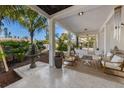 Covered patio with comfortable seating and a decorative fountain at 101 Tern Dr, Anna Maria, FL 34216