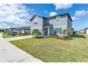 A well-maintained two-story home exhibits fresh landscaping and a long driveway on a sunny day at 11531 Moonsail Dr, Parrish, FL 34219