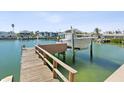 Dock with a boat lift on the canal with seawall and easy access to the open water at 12000 4Th St E, Treasure Island, FL 33706