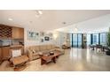Spacious living room with tile flooring, neutral decor, and plenty of natural light at 1211 Gulf Of Mexico Dr # 207, Longboat Key, FL 34228