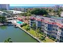Aerial view of Siesta Harbor condos with a pool, boat docks, waterfront access, and Gulf views at 1250 N Portofino Dr # 408Mar, Sarasota, FL 34242