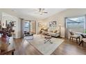 Bright living room with wood floors, comfortable seating, and sliding glass doors to the outside at 1709 Curry Trl # 30, Nokomis, FL 34275