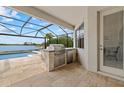 Outdoor kitchen, conveniently located next to the screened-in pool, perfect for outdoor dining and entertaining at 17610 Polo Trl, Bradenton, FL 34211
