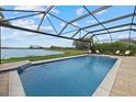 Enjoy the screened-in pool overlooking the lake and the gorgeous pool deck at 17610 Polo Trl, Bradenton, FL 34211