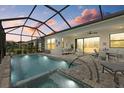 Inviting screened-in pool with connected spa and view of outdoor seating area, perfect for entertaining at 17814 Cresswind Ter, Bradenton, FL 34211