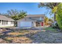 Beautiful two-story home with a two-car garage, a vibrant red front door, and a well-maintained yard at 2219 12Th W Ave, Bradenton, FL 34205