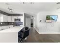 Modern kitchen featuring white cabinets, a breakfast bar, and sleek countertops at 2406 25Th W Ave, Bradenton, FL 34205