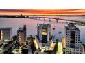 Stunning aerial view of waterfront property at sunset, featuring a scenic bridge and beautifully landscaped grounds at 280 Golden Gate Pt # 400, Sarasota, FL 34236