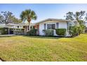 Charming single-story home with a lush lawn and a convenient carport at 3042 Lockwood Ter, Sarasota, FL 34231