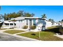 Cozy single-story home with a carport, neat landscaping, and a sunny, inviting facade at 3335 Spanish Oak Ter, Sarasota, FL 34237