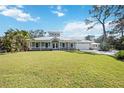 Beautiful single-story home featuring a metal roof, white picket fence and lush green lawn at 3595 Shamrock Dr, Venice, FL 34293