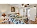 Comfortable bedroom with ceiling fan, ensuite bathroom, and serene decor at 3698 Lake Bayshore Dr # K-410, Bradenton, FL 34205