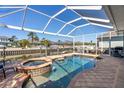 Gorgeous waterfront pool and spa with screened enclosure, offering stunning views of the canal at 428 Islebay Dr, Apollo Beach, FL 33572