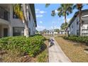 Scenic backyard view showcases a tranquil path and lush greenery, highlighting the property's serene setting at 4330 47Th W Ave # 104, Bradenton, FL 34210