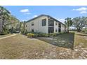Spacious condo building featuring a screened lanai and lush landscaping at 4330 47Th W Ave # 104, Bradenton, FL 34210