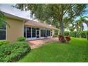 Private backyard featuring a screened lanai with a brick paver patio at 4790 Turnberry Cir, North Port, FL 34288