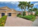 Lovely single-Gathering home featuring an attractive brick driveway and mature palm trees at 4790 Turnberry Cir, North Port, FL 34288