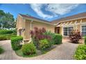 This single-Gathering home features beautiful landscaping with brick pavers and colorful plants at 4790 Turnberry Cir, North Port, FL 34288