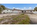 Single-story home featuring an attached garage and a spacious, undeveloped front yard at 507 59Th St, Holmes Beach, FL 34217