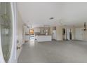 Open floor plan featuring a kitchen with breakfast bar and an adjacent outdoor pool at 507 59Th St, Holmes Beach, FL 34217