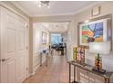 Hallway showcasing artwork, neutral colors, tile flooring, and decorative lighting fixtures at 5420 Eagles Point Cir # 106, Sarasota, FL 34231