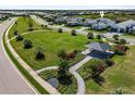 Aerial view of community park with gazebo and lush landscaping in residential neighborhood at 7928 Redonda Loop, Bradenton, FL 34202