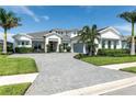 Beautiful home featuring a paved driveway, manicured lawn, and lush landscaping at 7928 Redonda Loop, Bradenton, FL 34202