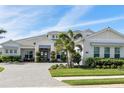 Beautiful one-story home with manicured landscaping, a gray roof and paver driveway at 7928 Redonda Loop, Bradenton, FL 34202