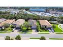 Aerial view of houses with tile roofs, well-maintained lawns, and palm trees, showing community layout and nearby surroundings at 8188 Gabanna Dr, Sarasota, FL 34231