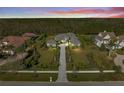 Sprawling single-story home with well-manicured lawn, mature trees, and a long driveway at 8455 Lindrick Ln, Bradenton, FL 34202