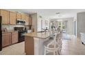 Beautiful kitchen featuring a granite island with bar stool seating at 8928 Excelsior Loop, Venice, FL 34293