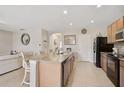 Open concept kitchen with large island and modern appliances at 8928 Excelsior Loop, Venice, FL 34293