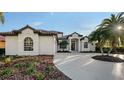 Well-maintained front exterior with lush landscaping and beautiful architectural details at 9818 Old Hyde Park Pl, Bradenton, FL 34202