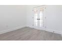 Office featuring gray wood-look vinyl plank flooring and white french doors at 10 Mast Dr # 1, Placida, FL 33946