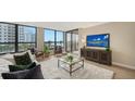 Inviting living room showcasing modern decor, comfortable seating, and large windows with views at 11 Sunset Dr # 303, Sarasota, FL 34236