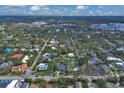 Overhead view of home and neighborhood with mature trees and city skyline in distance at 1231 S Orange Ave, Sarasota, FL 34239