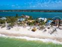 Breathtaking beachfront home surrounded by lush landscaping and pristine turquoise waters at 1304 Casey Key Rd, Nokomis, FL 34275