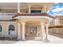 Grand front entry featuring stately columns, tiled roofing, and a welcoming double-door entrance at 1304 Casey Key Rd, Nokomis, FL 34275