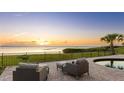 Gorgeous outdoor patio with comfortable seating overlooking the serene water and sunset at 202 Gaines Ave, Sarasota, FL 34243