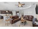 Open concept living area with modern furniture, kitchen and lots of natural light at 220 Cassano Dr, Nokomis, FL 34275