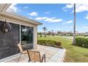 View of the backyard patio showing the outdoor chairs and landscaped backyard at 2904 Captains Ct # 2904, Palmetto, FL 34221